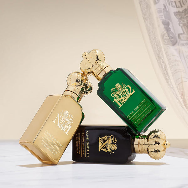 Clive Christian travel bottles resting on draped cream fabric